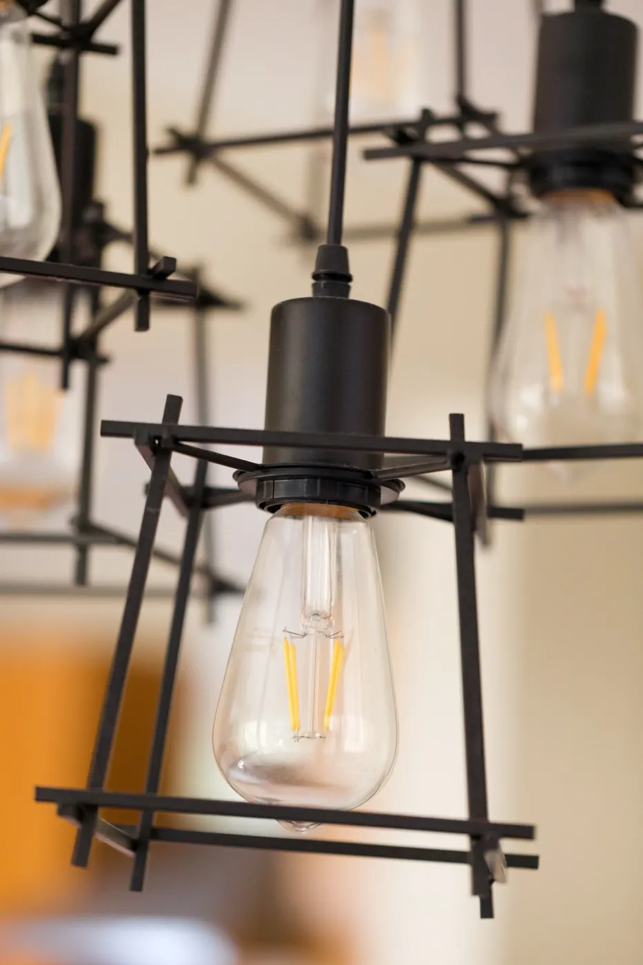Bulb inside a black-framed pendant light