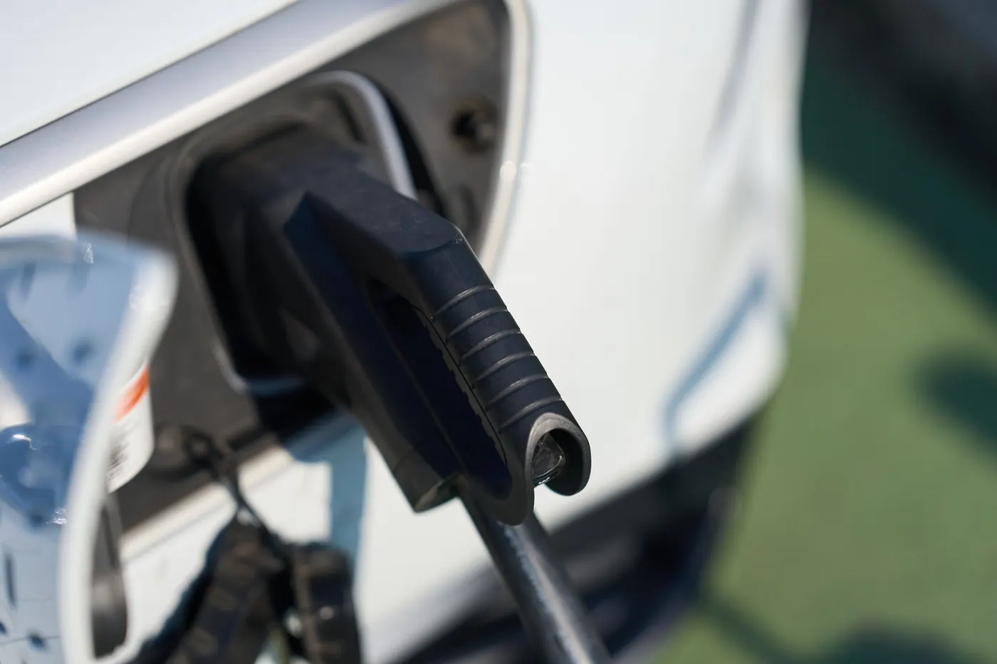 Electric vehicle charging connector plugged into a car