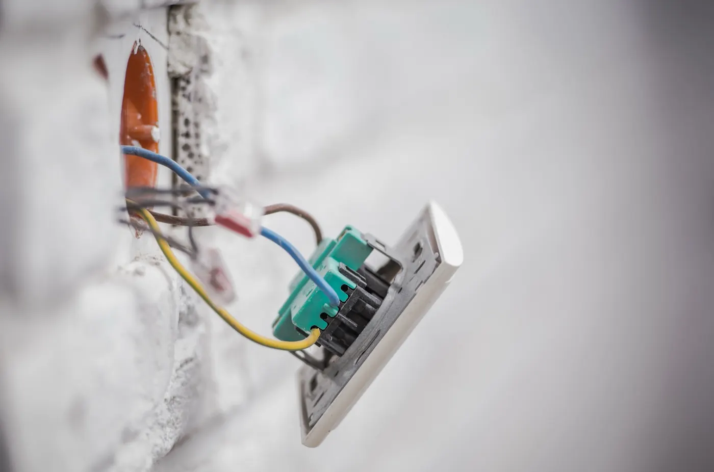 Electrical wires exposed in a wall outlet box