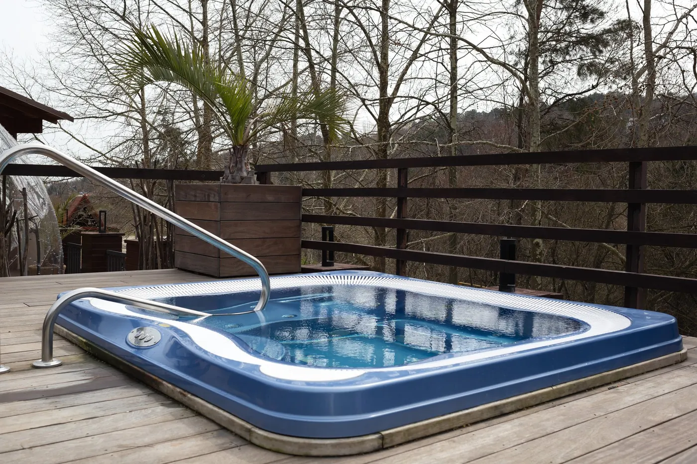 Outdoor hot tub with built-in jets on a wooden deck