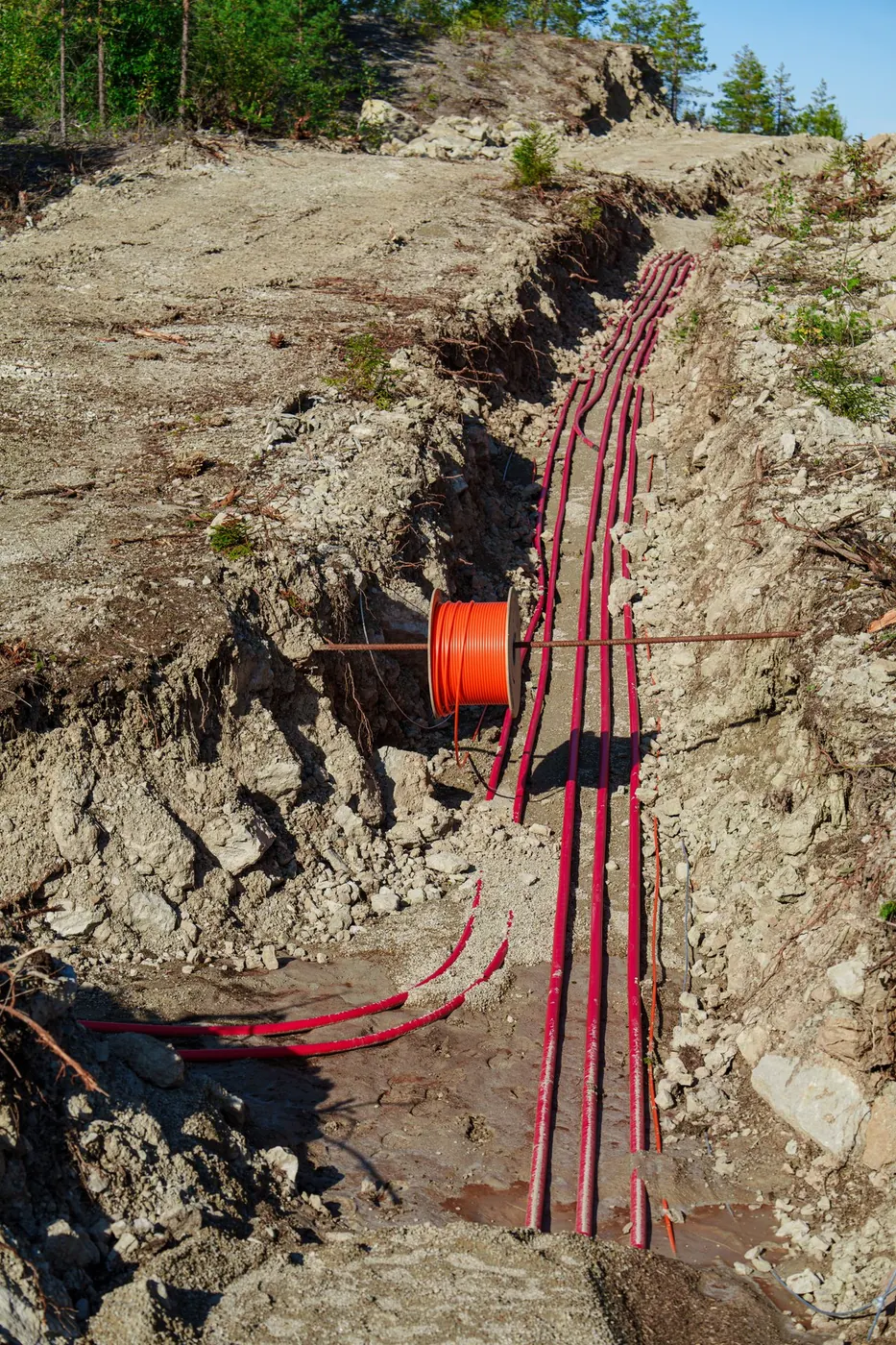 Electrical cables exposed in an underground trench