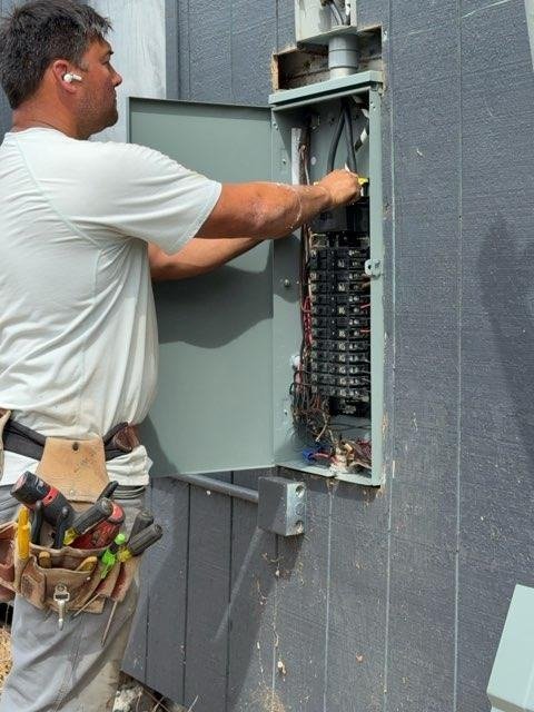 ZZ Electric electrician servicing an electrical panel